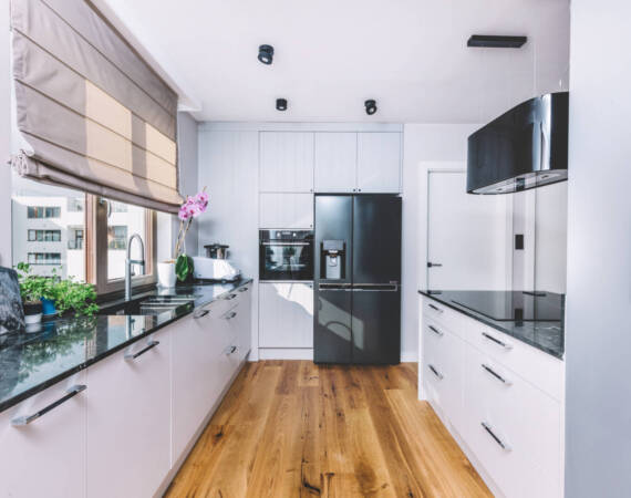 Modern kitchen interior design. Wooden floor and quartzite tabletop